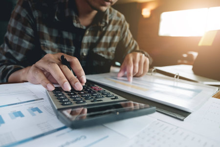 businessman working with calculator for financial document in office. male accountant doing accounting and calculating. bookkeeper making calculation. Savings, financeの写真素材