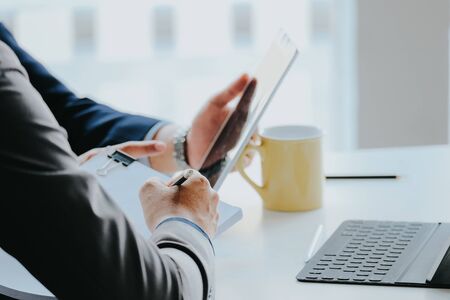 Business team discussing ideas for a marketing trend with digital tablet.の写真素材