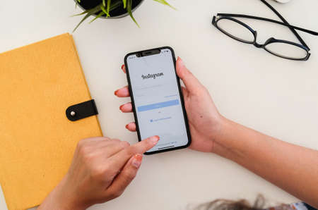 CHIANG MAI, THAILAND - JAN 19 2020 : Woman hand holding iphone xs with instagram application. Instagram is largest and most popular photograph social networking.のeditorial素材