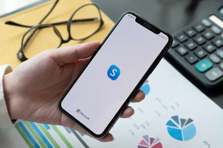 CHIANG MAI,THAILAND - APR 06, 2020 : Woman holding iphone Xs with Skype application, Skype is part of Microsoft,のeditorial素材
