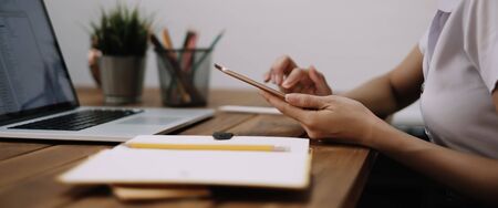 Young woman using digital tablet and computer for studying or working online at home