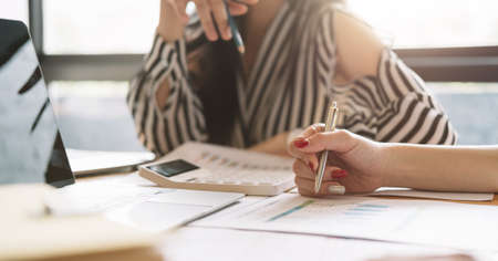 Close up of businessman or accountant working on calculator to calculate business data, accountancy...