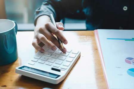 Close up a account working about financial with calculator at office to calculate expenses, Accounting conceptの写真素材