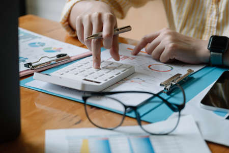 Accountant or banker calculate the financial report with calculatorの写真素材