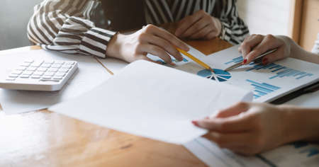 Closeup Group of Business analyzing investment graph from financial report and meeting brainstorming discussing planの写真素材