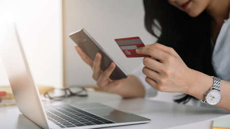 Shopping online with smartphone and credit card on handの写真素材