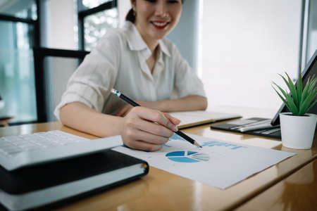 usiness man investment consultant analyzing company annual financial report balance sheet statement working with documents graphs. Concept picture of business, market, office, taxの写真素材