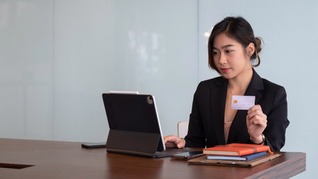 Busiesswoman holding creditcard and using laptop computer for online shopping, Online Payment, e-commerce, internet banking.の写真素材