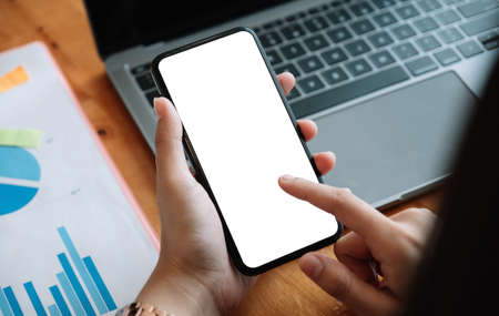 Woman holding and touch a smartphone blank screenの写真素材
