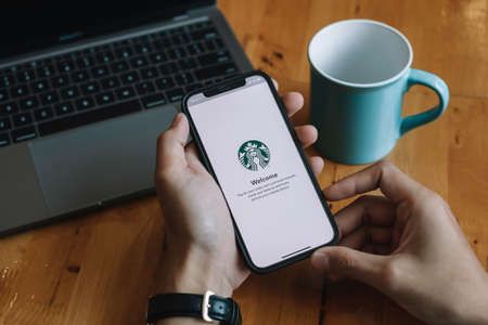 CHIANG MAI, THAILAND - JAN 23, 2021 : Starbucks app on the Apple iPhone display screen. opening online menu page of Starbucks website, Starbucks coffee shop.のeditorial素材