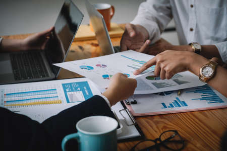 Shot of Business team working new startup project and discussing the charts and graphs showing the results at meeting accounting and financial.の写真素材