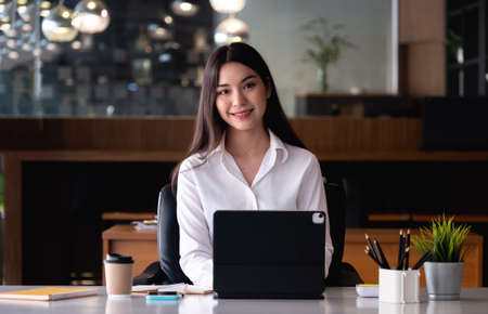 Portrait Of Attractive Asian Businesswoman Working On Laptop at her office.の写真素材