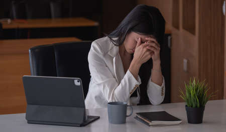 Businesswoman get stressed and headache while having a problem.の写真素材
