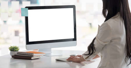 Side view of businesswoman hands typing text on a wireless keyboard. Business woman working at the officeの写真素材