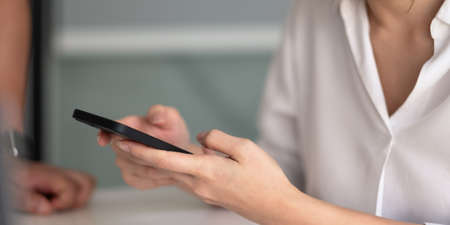 Close up hand of woman using samrtphoneの写真素材