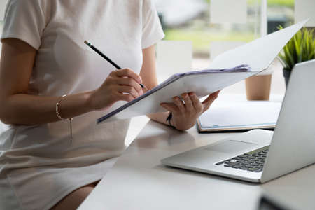 Audit working, Businessman work with paper document on clipping board in officeの写真素材
