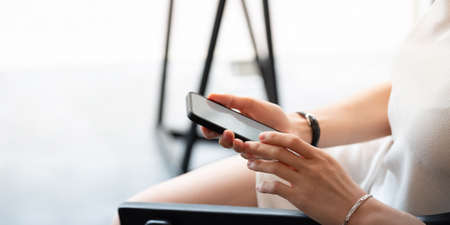 Close up business woman using smart phone at cafeの写真素材