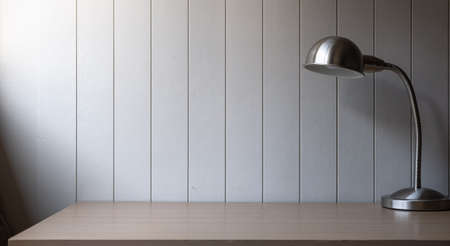 Workplace with space - Lamp on old wood table with space of rough cement wall in white color toneの写真素材