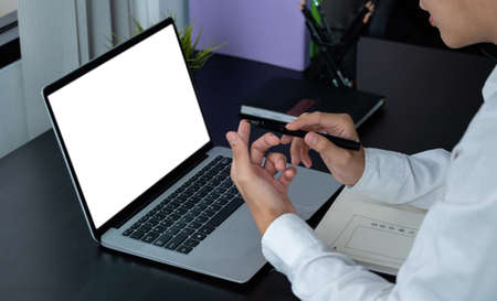 young man wearing headphones looking at laptop monitor, listening to educational lecture webinar,...