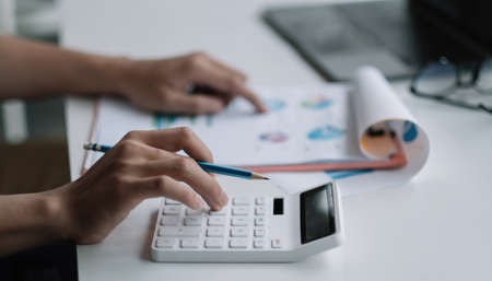 Close up businessman using calculator for analysis maketing plan, Accountant calculate financial...
