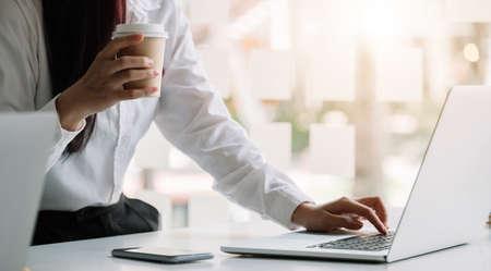 Businesswoman working on computer at table in office,の写真素材