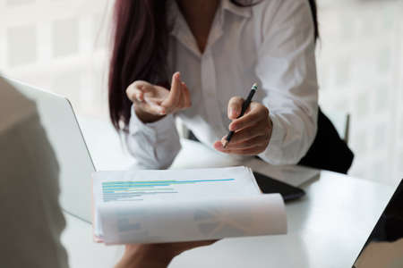 Close up business adviser meeting to analyze and discuss the situation on the financial report in the meeting room.Investment Consultant,Financial Consultant,Financial advisor and accounting conceptの写真素材