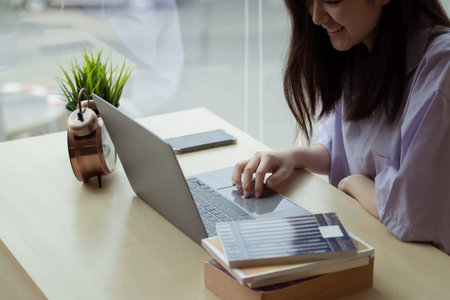 Online education. Asian girl online lesson using a computer video call to a virtual teacher at homeの写真素材