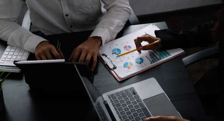 Two business teamwork calculating a valuation in workplace.の写真素材