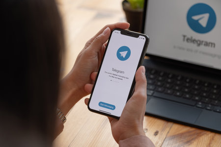 CHIANG MAI, THAILAND, MAR 21, 2021 : Woman hand holding iPhone X with social networking service Telegram on the screen. iPhone 10 was created and developed by the Apple incのeditorial素材