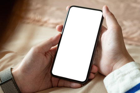 Close up of woman using cell phone with black screen, texting video callsの写真素材