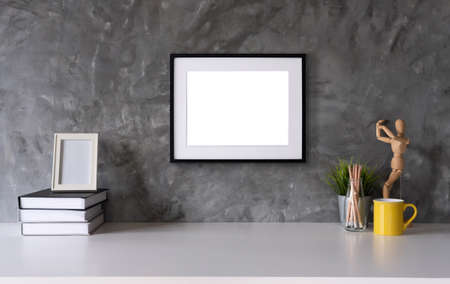 White desk with photo frame, office supplies, book natural leaf inin design vaseの写真素材