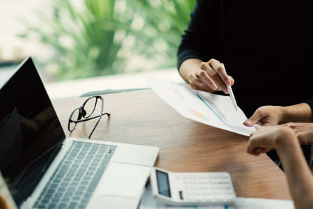 Close up business adviser meeting to analyze and discuss the situation on the financial report in the meeting room.Investment Consultant,Financial Consultant,Financial advisor and accounting concept.の写真素材