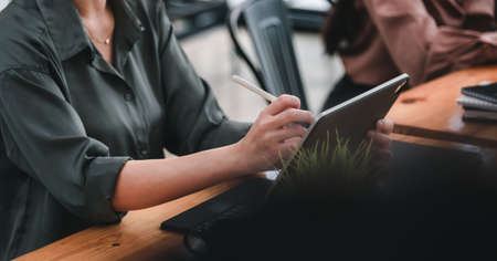 business people holding pen stylus working with digital teblet at office.の写真素材