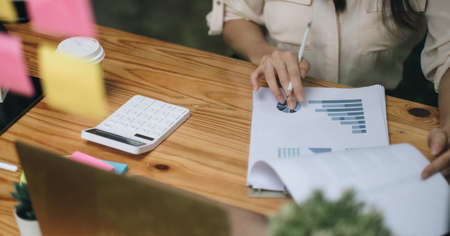 Accountant or bookkeeper using calculator counting finances taxes fees accounting calculate bills money planning budget loan payment concept pay online on computerの写真素材