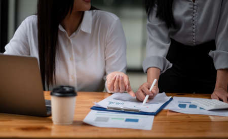 Business adviser analyzing financial figures denoting the progress in the work, consult conceptの写真素材