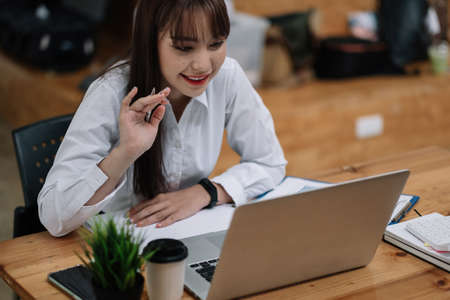 Young asian woman video call meeting on laptop computer for business or education online learning