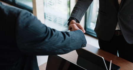 Businessman handshake for teamwork of business merger and acquisition,successful negotiate,hand shake,two businessman shake hand with partner to celebration partnership and business deal concept.の写真素材