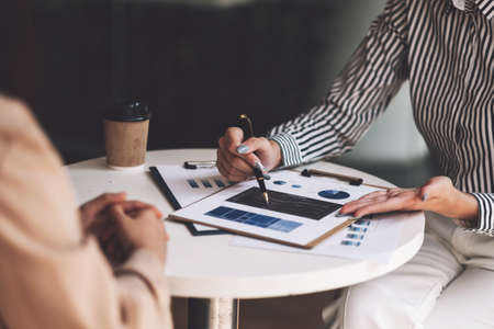 Group of Businesswoman and Accountant checking data document on paperwork chart report for investigation of corruption accountの写真素材