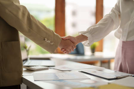 Close up of Business people shaking hands, finishing up meeting, business etiquette, congratulation,...