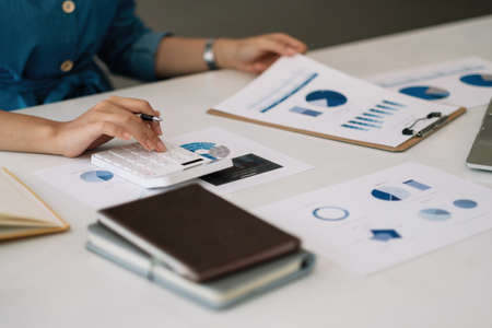 Close up hand of accountant working with computer and calculator for business and financial expenseの写真素材