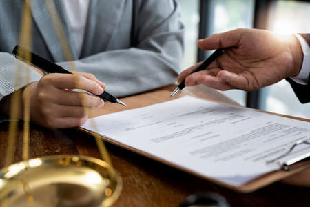 business people and lawyers discussing contract papers sitting at the table. Concepts of law,...