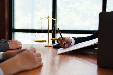 The hand of a business man is using the index finger to let the customer sign the contract,...