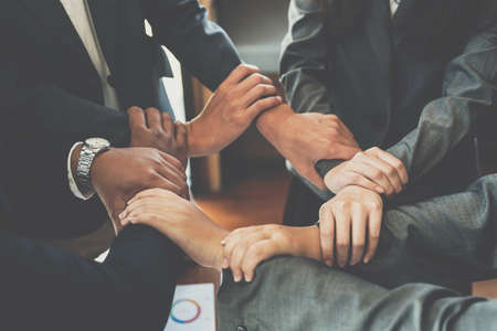 Group of diverse hands holding each other support together teamwork aerial view