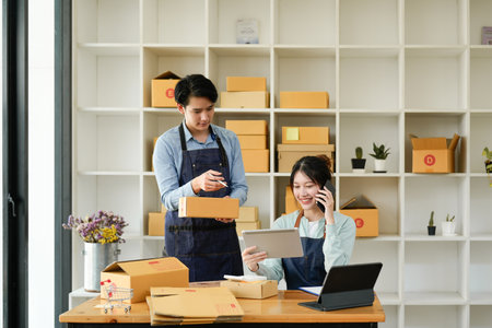 Shot of Young couple entrepreneur, start up teenager business SME owner work at home.の素材 [FY310192052334]