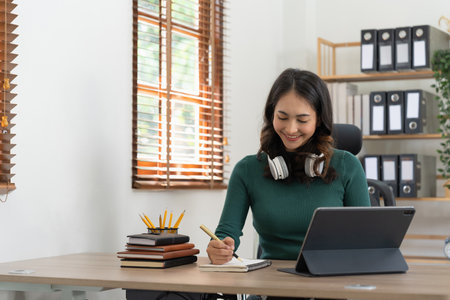 Smiling girl student wear headphone study online with laptop computer, happy young woman learn...