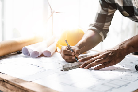 engineer architect drawing a blue print design building or house, An engineer workplace with...