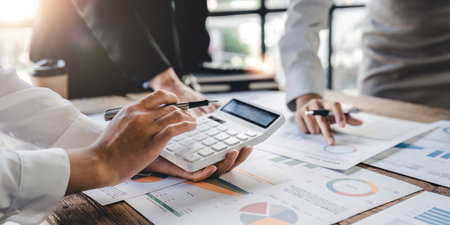 Businesswoman or accountant working Financial investment on calculator, calculate, analyze business and marketing growth on financial document data graph, Accounting, Economic, commercial conceptの写真素材