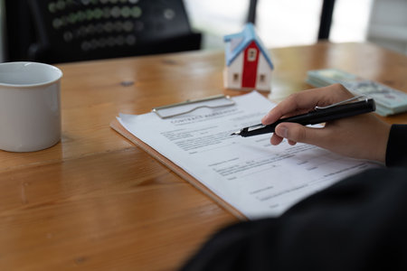real estate agent holding pen to his client for signing contract,concept for real estate, moving...