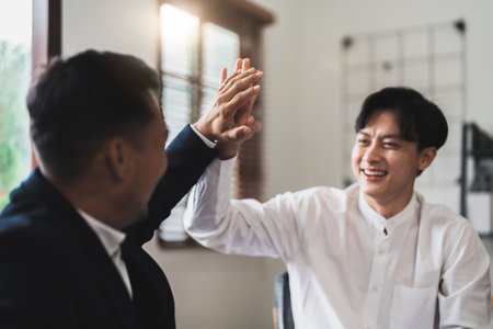 Achievement and Business Goal Success Concept - Business people with high five giving for business success achievementの写真素材