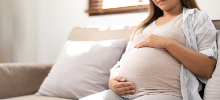 pregnancy, rest, people and expectation concept - close up of happy smiling pregnant woman in and...